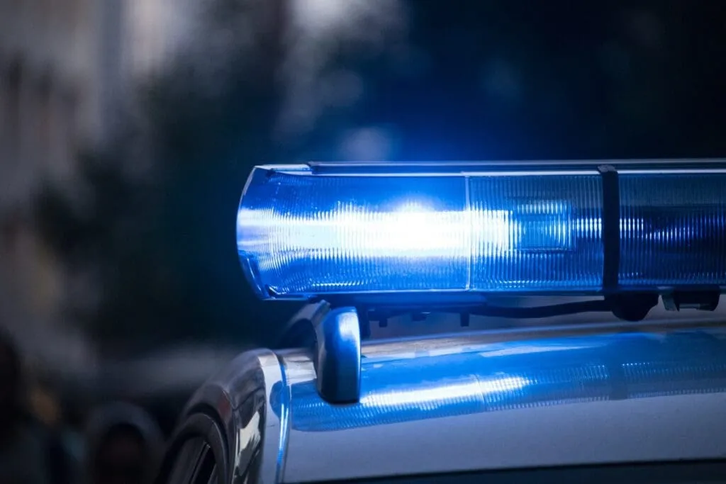 Blue police lights flashing on a vehicle, symbolizing legal matters for a Sex Crimes Attorney in Syracuse.