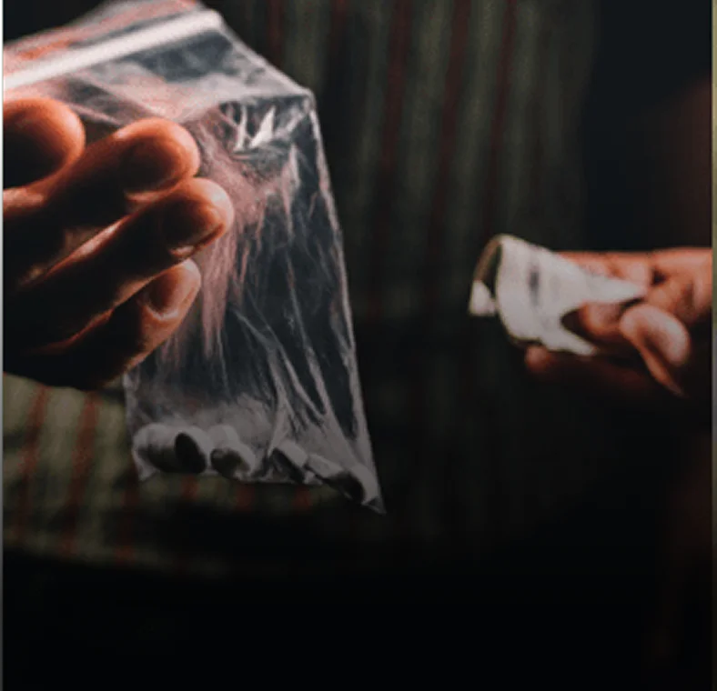 Drug possession attorney: Hands exchanging drugs for money
