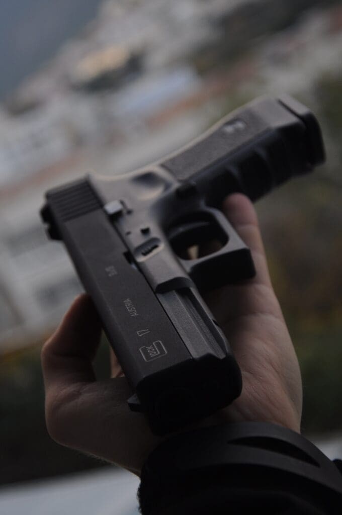 Glock 17 pistol held by hand, relevant for weapons attorney in Syracuse